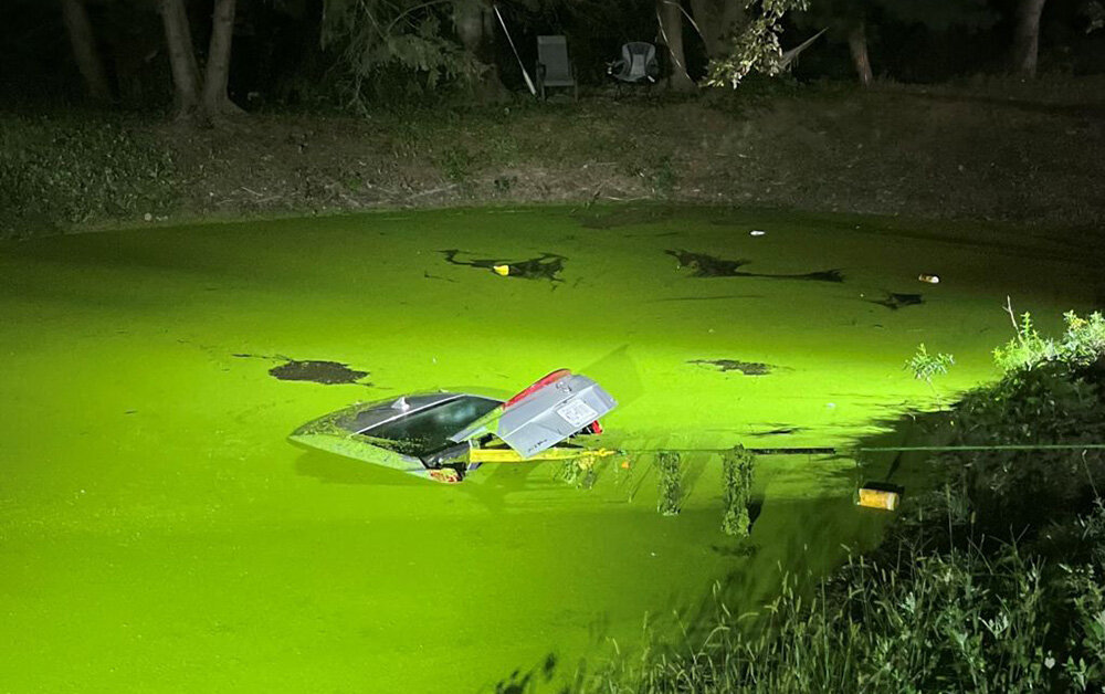 A vehicle driven by Melissa Branagan is partially submerged in a pond on Marchese Drive.